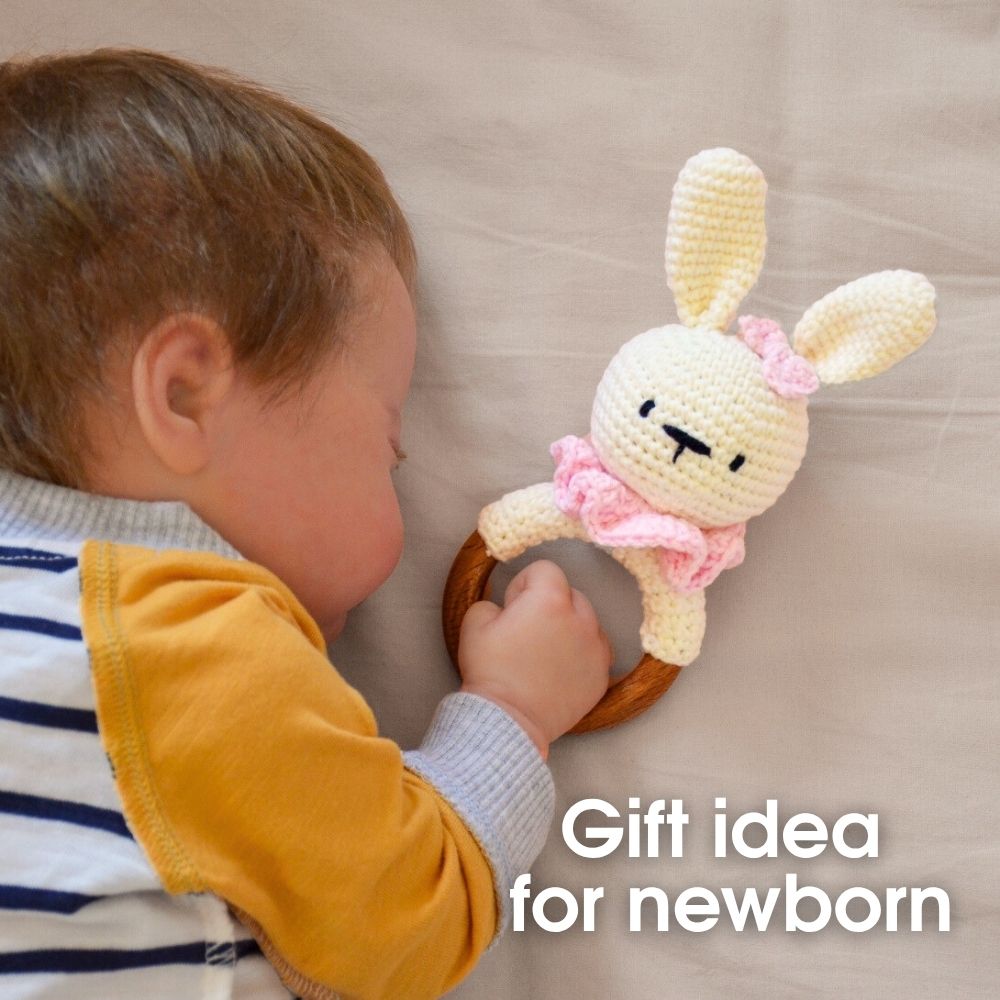 Sleeping baby with crochet bunny rattle – handmade toy pattern.