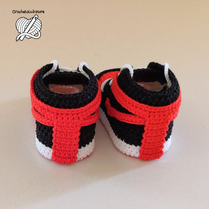 Detailed shot of handcrafted baby sneakers with focus on crochet texture and pattern precision.
