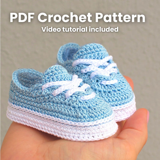 Blue crochet baby sneakers held in hands — PDF crochet pattern with video tutorial