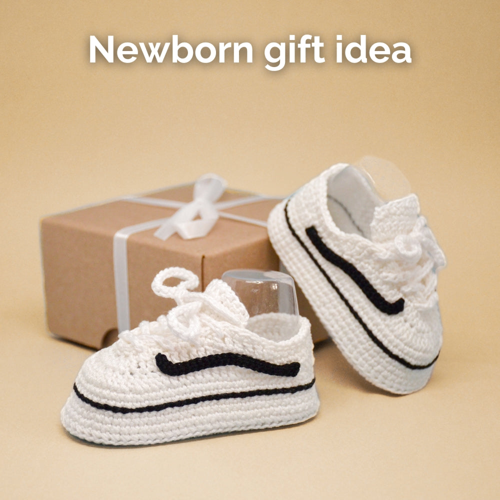 lack and white crochet baby sneakers in a gift box with ribbon — newborn gift idea