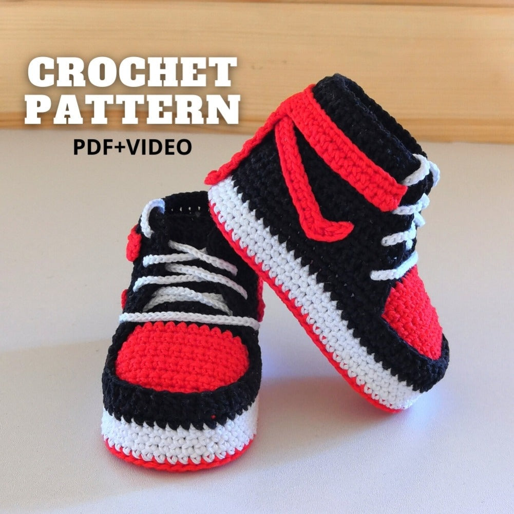 Crochet baby basketball sneakers inspired by Nike® Jordans® displayed on a wooden background, illustrating style and versatility.