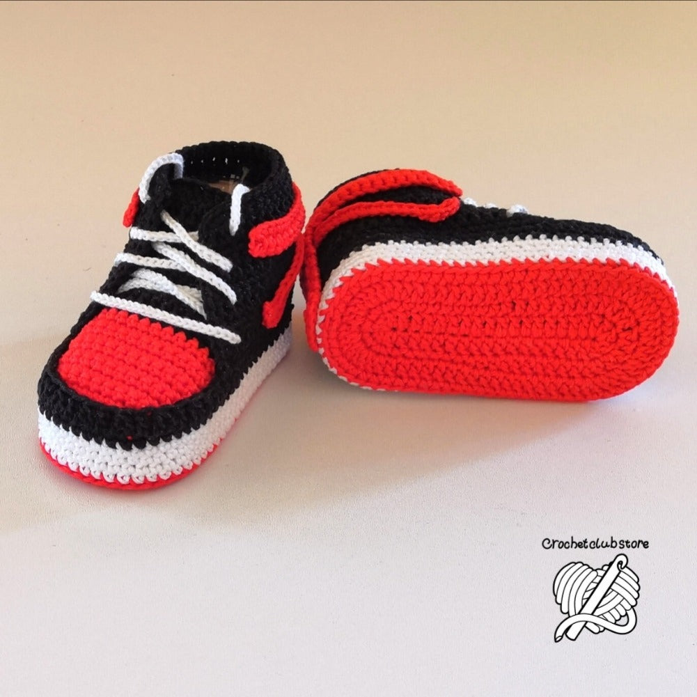 Rustic presentation of crochet baby sneakers, emphasizing quality design and natural aesthetics.