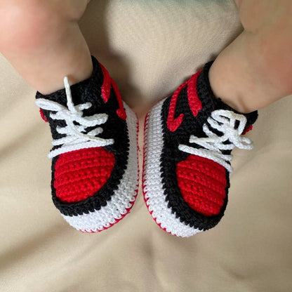 Close-up on the intricate crochet work of baby sneakers inspired by nike jordans, highlighting the attention to detail.