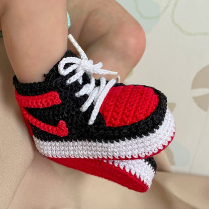 Hand-crocheted baby basketball sneakers in vibrant colors, showcasing intricate stitch details and laces.