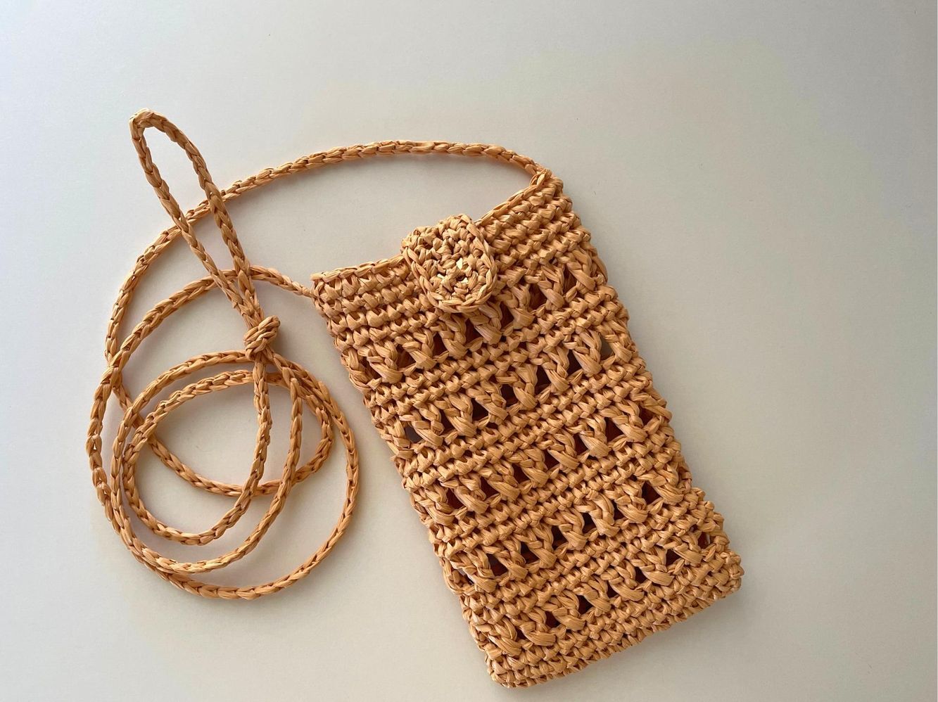 crochet raffia phone bag with crossbody strap