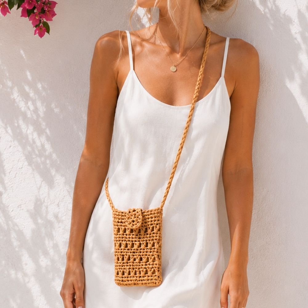 Summer raffia mini purse worn with white linen dress