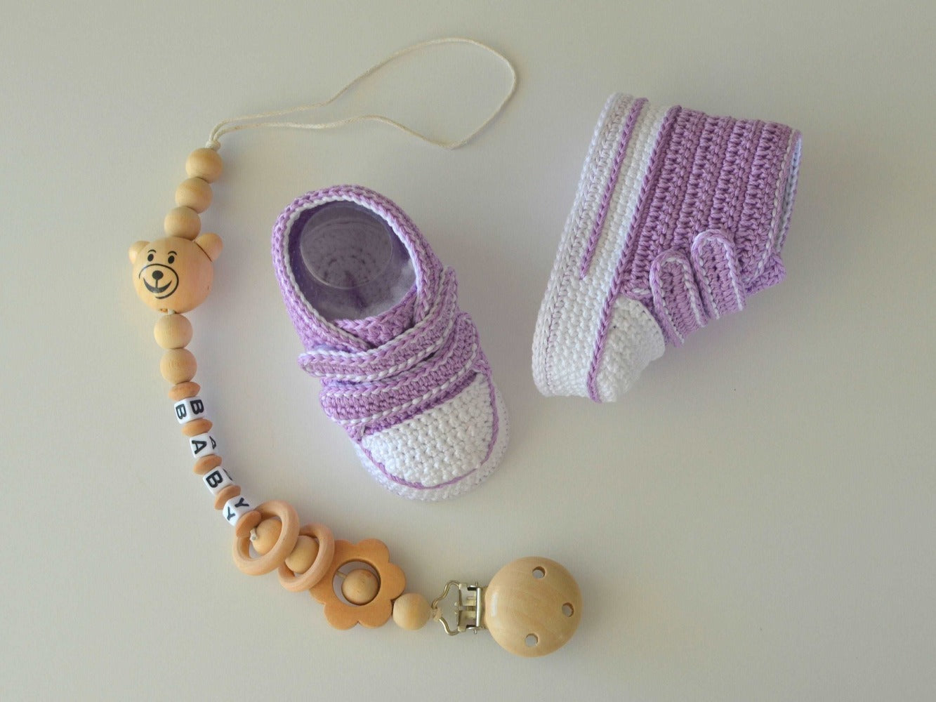 Soft cotton baby booties with detailed crochet pattern.